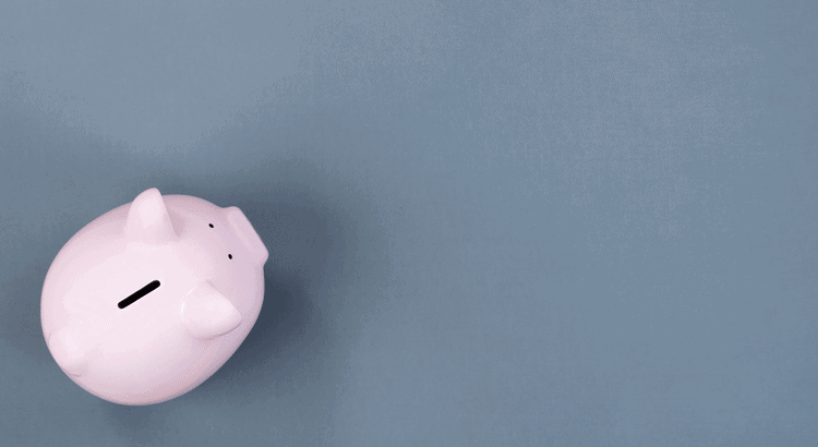 Piggy bank with coin slot on a blue background, symbolizing saving money.