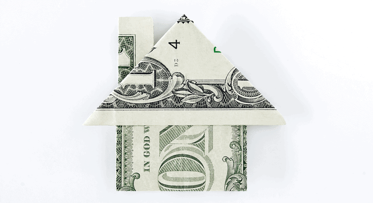 Dollar bill folded into house shape for real estate or financial concept.