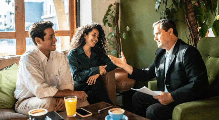 Real estate agents discussing with clients at a cozy cafe in Walnut Creek, CA.