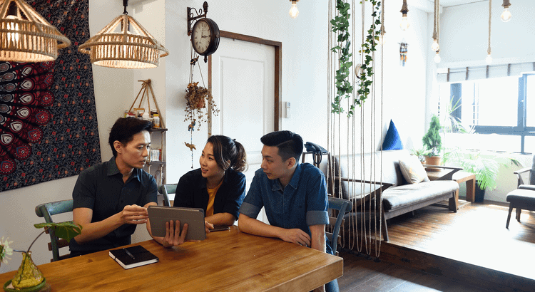 Walnut Creek real estate agents discussing property options in a cozy, well-lit home.