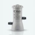 Vitalis Flow Controller unit with pipe fittings, labelled 24/7 Quiet, Reliable and Safe, Energy Efficient