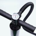 Close up of the manual hand air pump showing its pressure gauge, T handle and ribbed hose