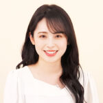 Smiling woman with long dark hair in a white top, customer testimonial avatar