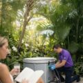 Cool Bionic technician attaching a hose to a covered Vitalis 3 tub in a garden, concierge service visit