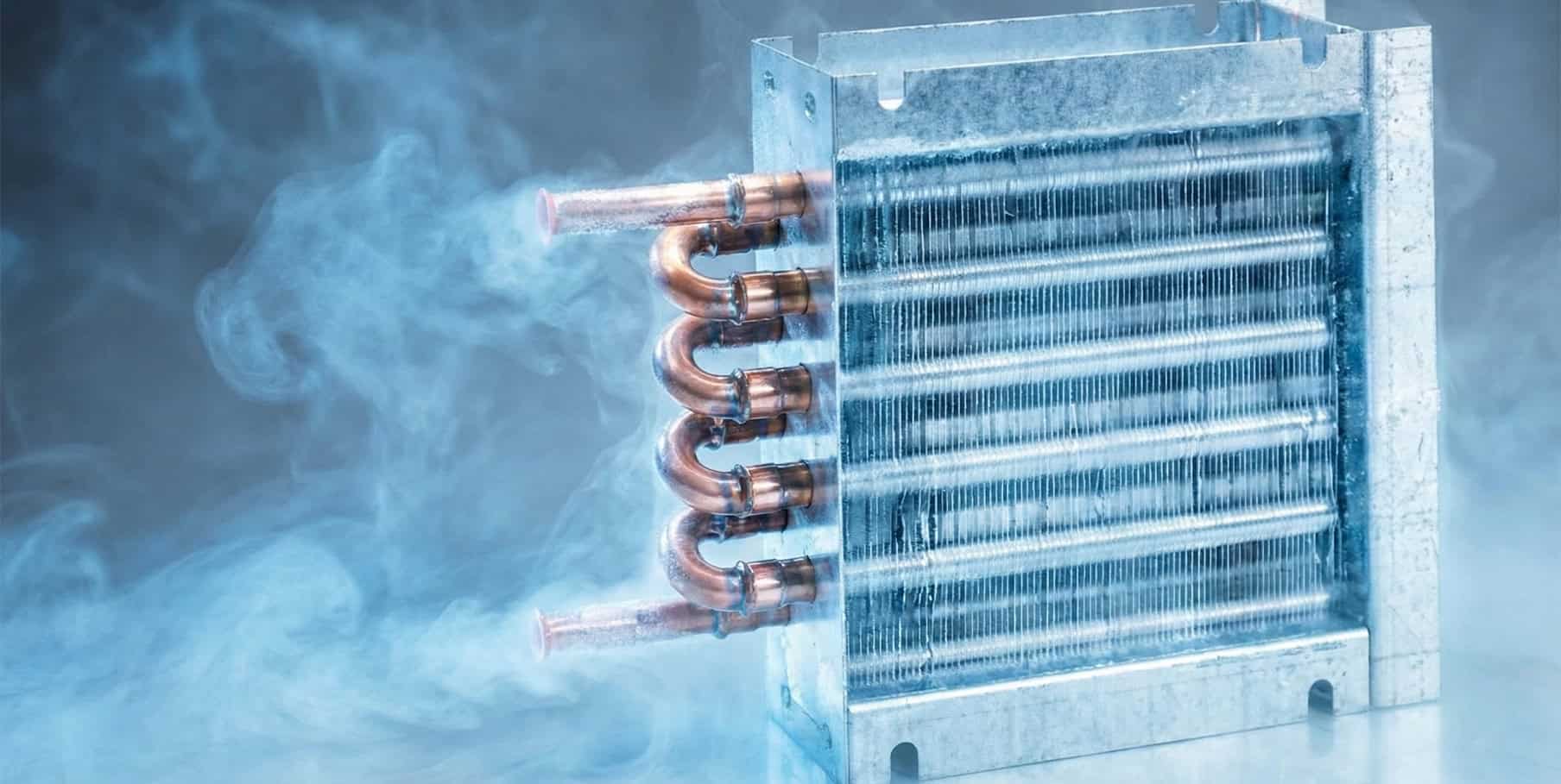 Frosted heat exchanger fins and copper pipes of the cooling unit surrounded by cold vapor