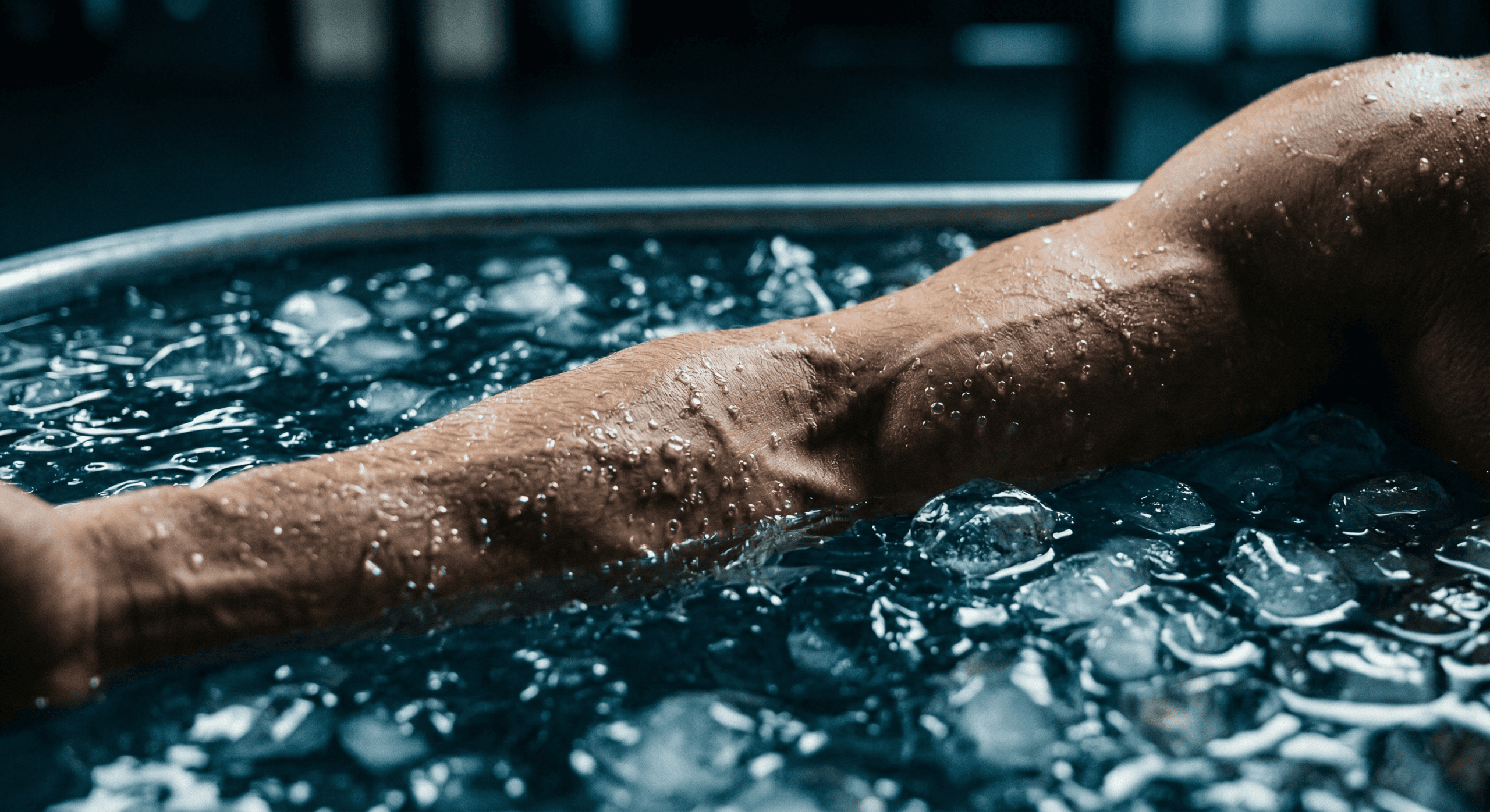 Athlete's leg submerged in crushed ice during an ice bath recovery session