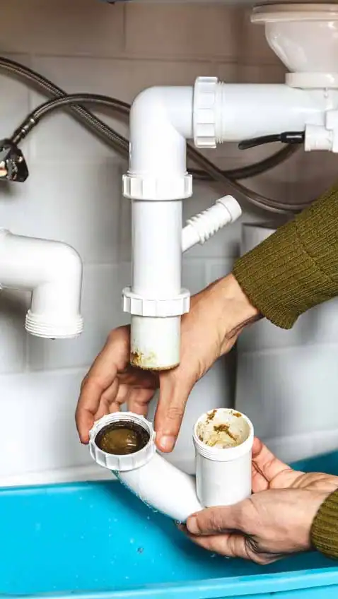 Clogged drain repair by professional plumber with clear pipes and plumbing system maintenance services.