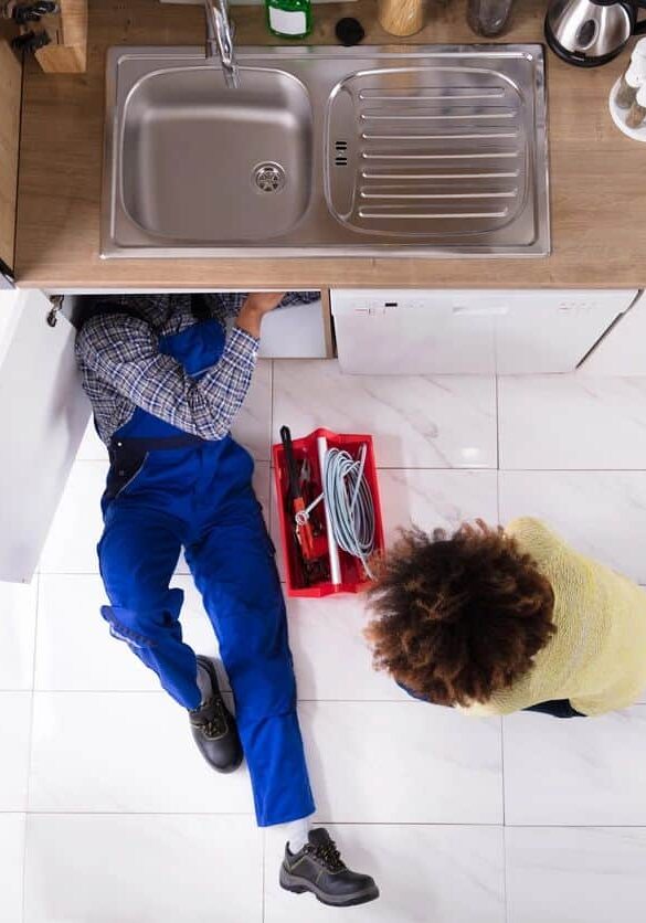 Clogged kitchen sink repair by professional plumber in home kitchen, plumbing troubleshooting services, Cornwell Plumbing expertise on drain clearing and plumbing repairs, drain cleaning, sink repair, plumbing emergency services, kitchen plumbing solutions for homeowners, reliable plumbing technicians.