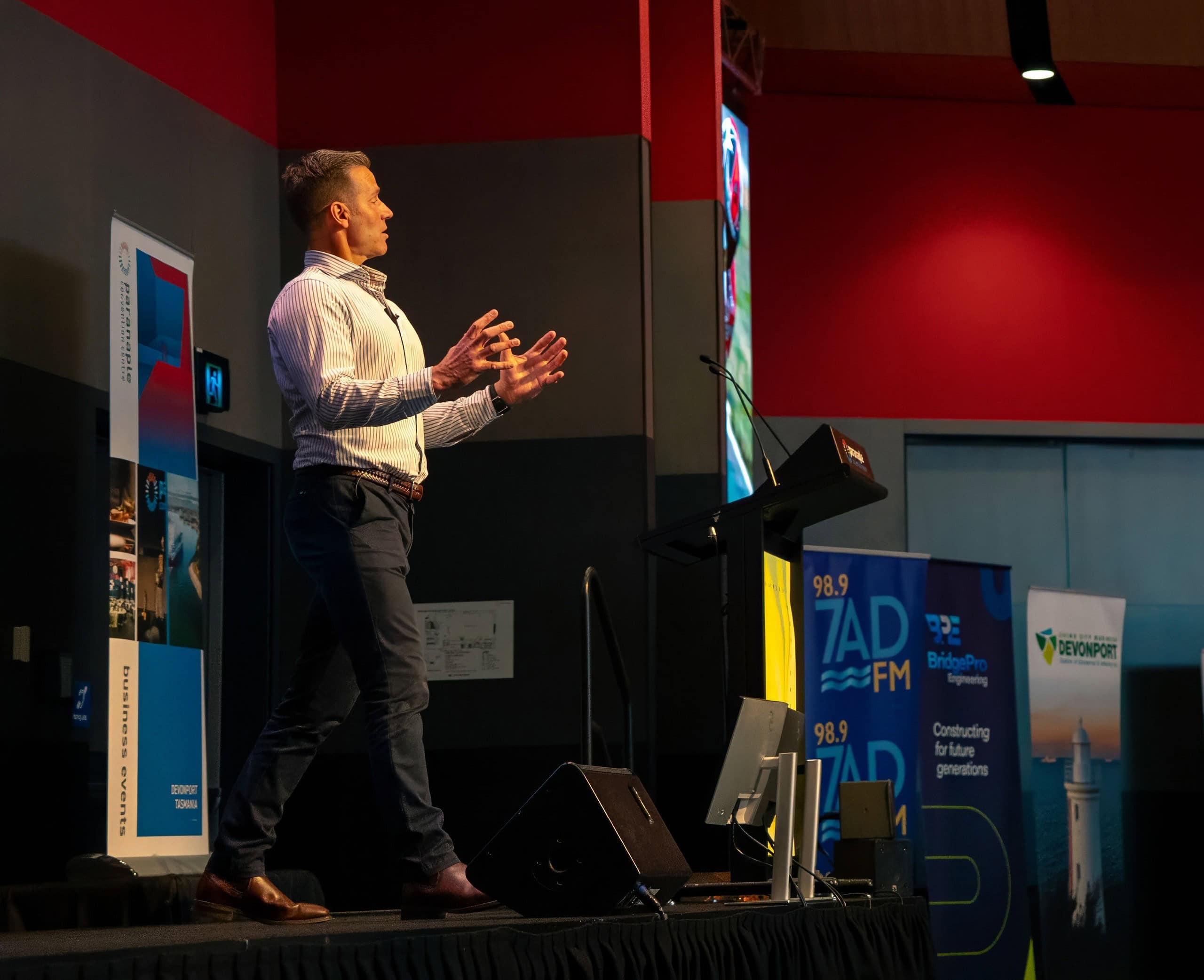 Ant Williams speaking on stage at a corporate conference
