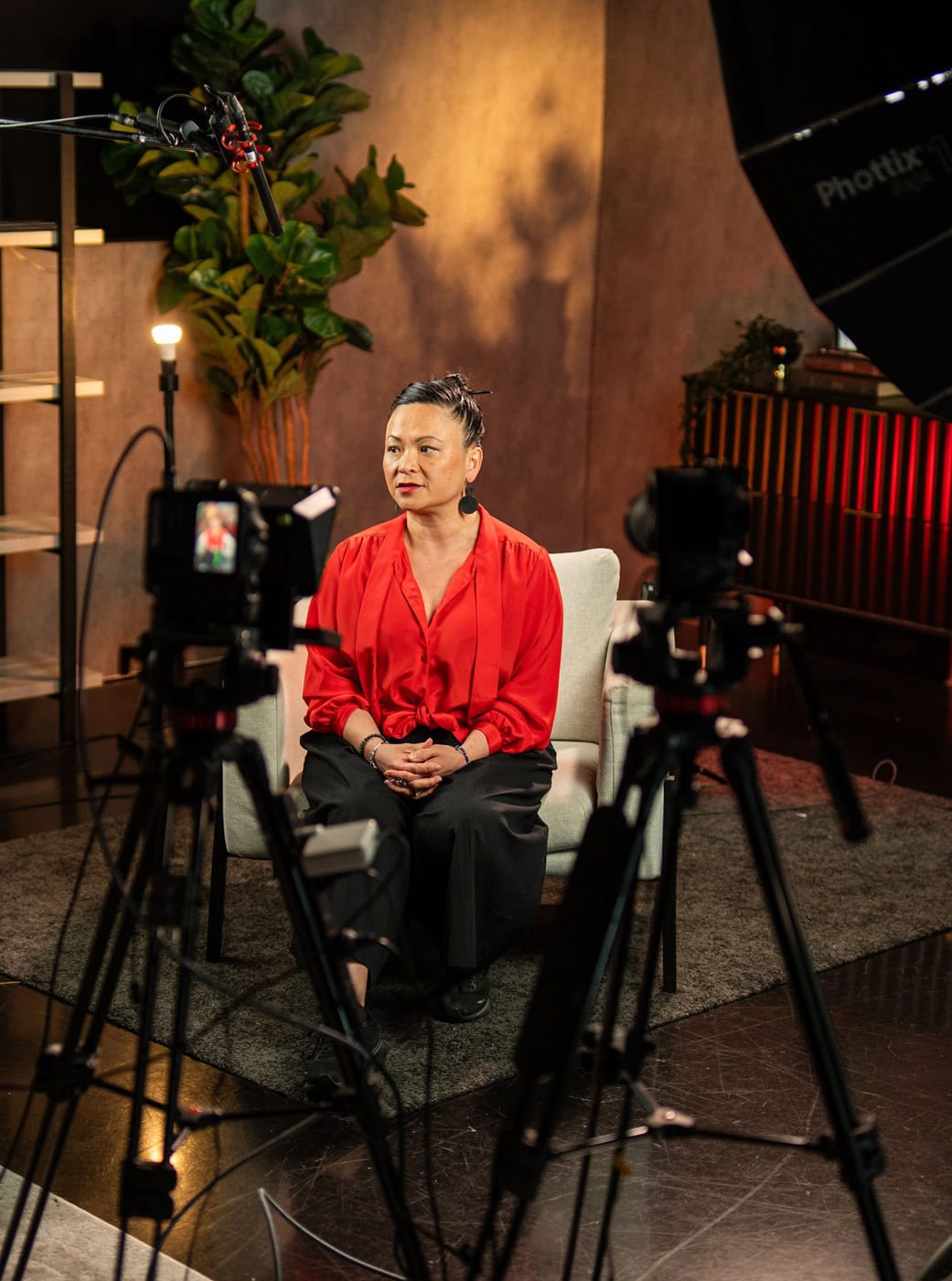 Pauline Nguyen being interviewed on a studio set