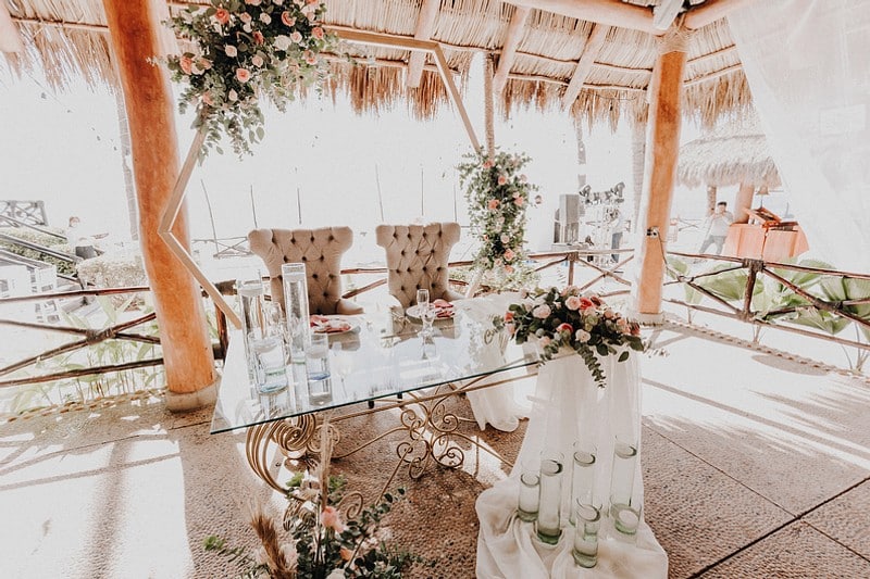 A picturesque wedding ceremony in Mexico, featuring a couple exchanging vows surrounded by vibrant decorations and guests.