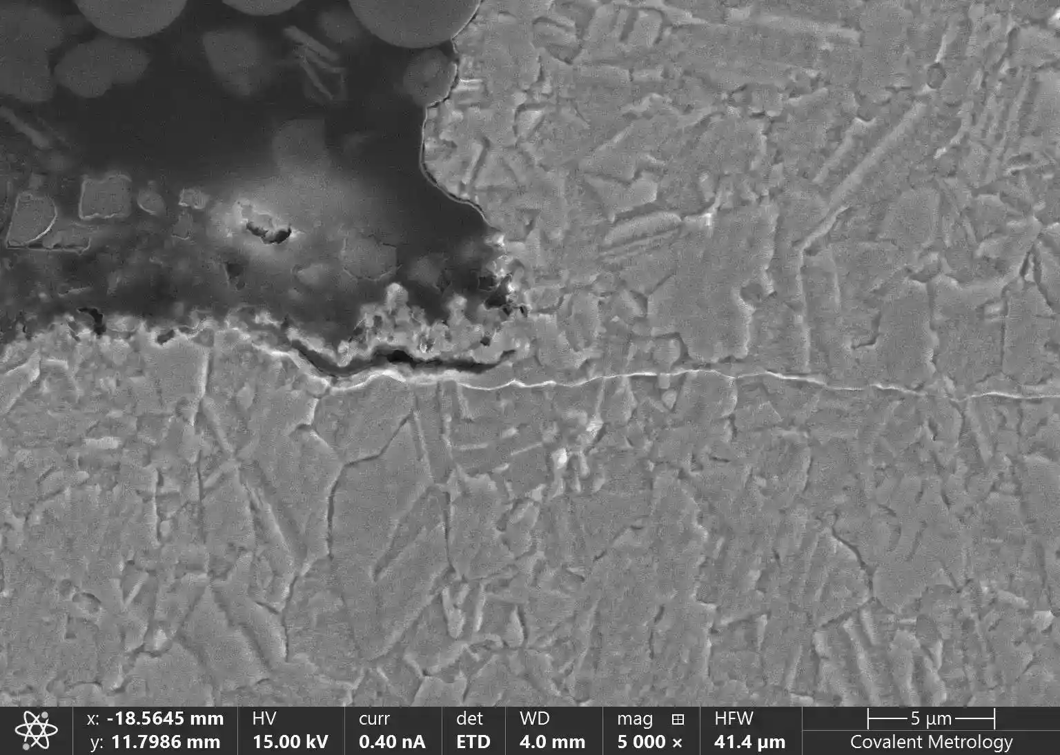 Secondary electron SEM image showing cross‑section microstructure of etched copper sample, highlighting grain boundaries and surface features