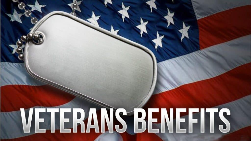 Dog tag with "Veterans Benefits" text on US flag background, symbolizing military service and vetera.