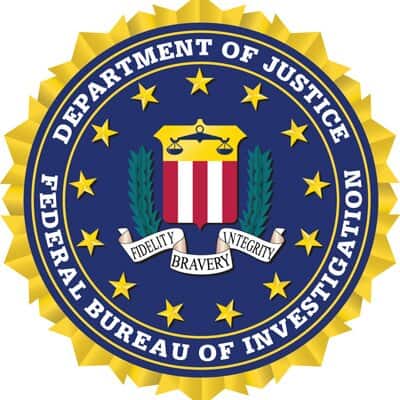 Badge of the Federal Bureau of Investigation (FBI) with Department of Justice emblem.