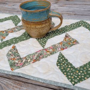 quilted table runner with a pottery mug