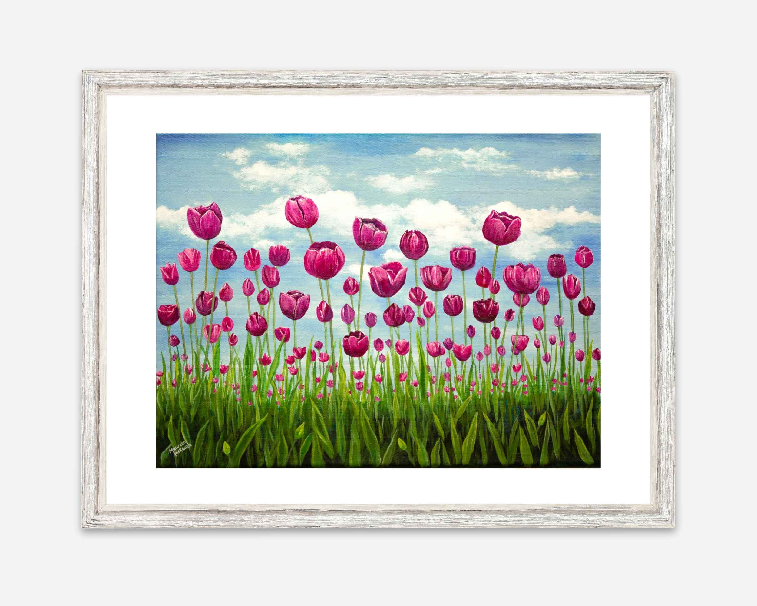 a giclee print of a field of pink vibrant tulips standing tall in a green field. The sky behind them is soft blue with fluffy clouds