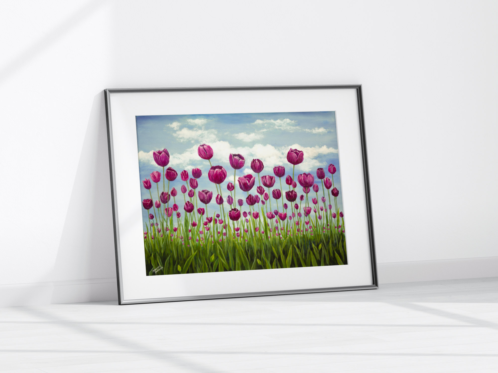 a giclee print of a field of pink vibrant tulips standing tall in a green field. The sky behind them is soft blue with fluffy clouds