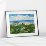 giclee print of seal island nova scotia featuring a shanty, a clothesline with clothes and a quilt and a green cart on a rocky field.