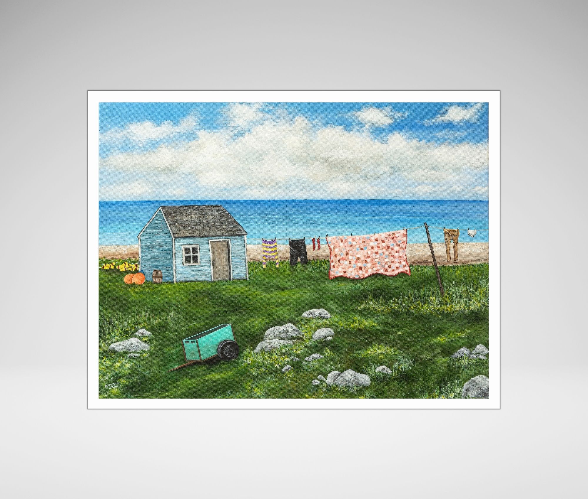 giclee print of seal island nova scotia featuring a shanty, a clothesline with clothes and a quilt and a green cart on a rocky field.