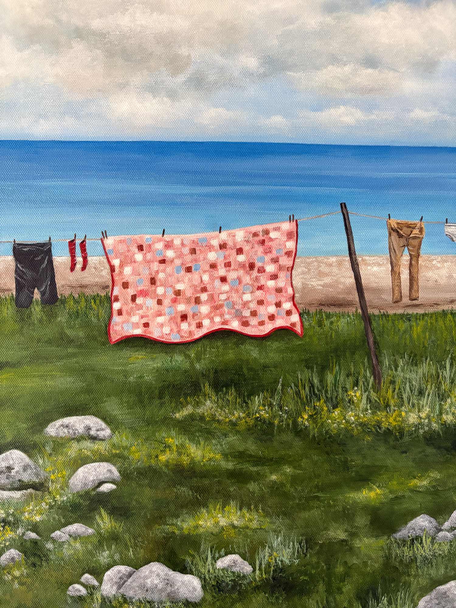 a close up of a print showing a quilt and clothes on a clothesline