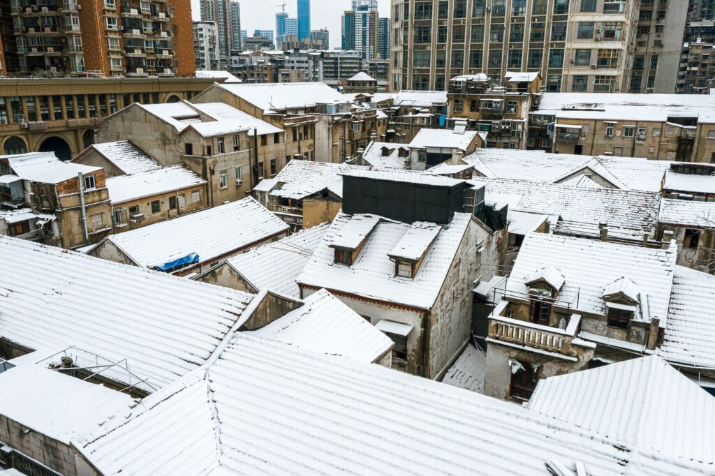 Aerial shot of buildings covered in snow in Wuhan China Crazy Horse Roofing winter roof protection