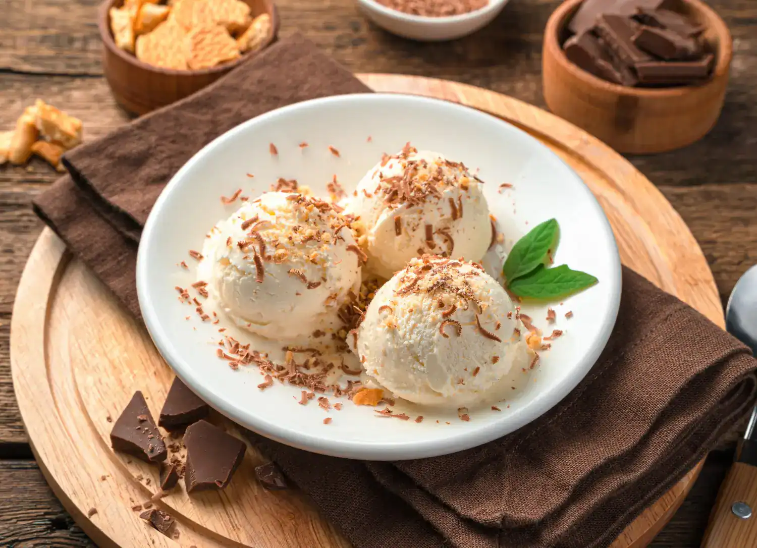 Delicious butterscotch ice cream served in a white bowl with chocolate shavings.