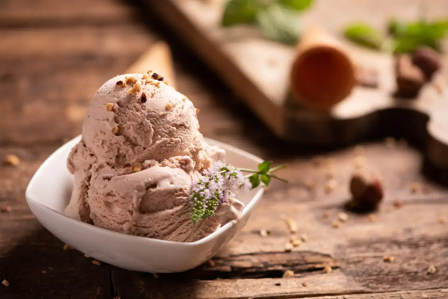 Delicious chai spice ice cream served in a white bowl on rustic wooden table.