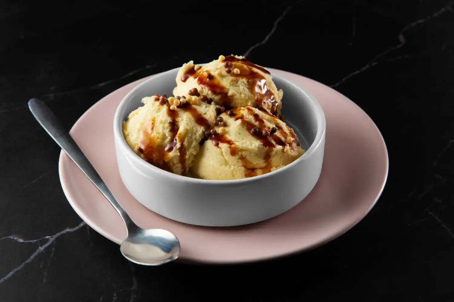 Delicious cinnamon apple sorbet served in a white bowl with caramel drizzle.