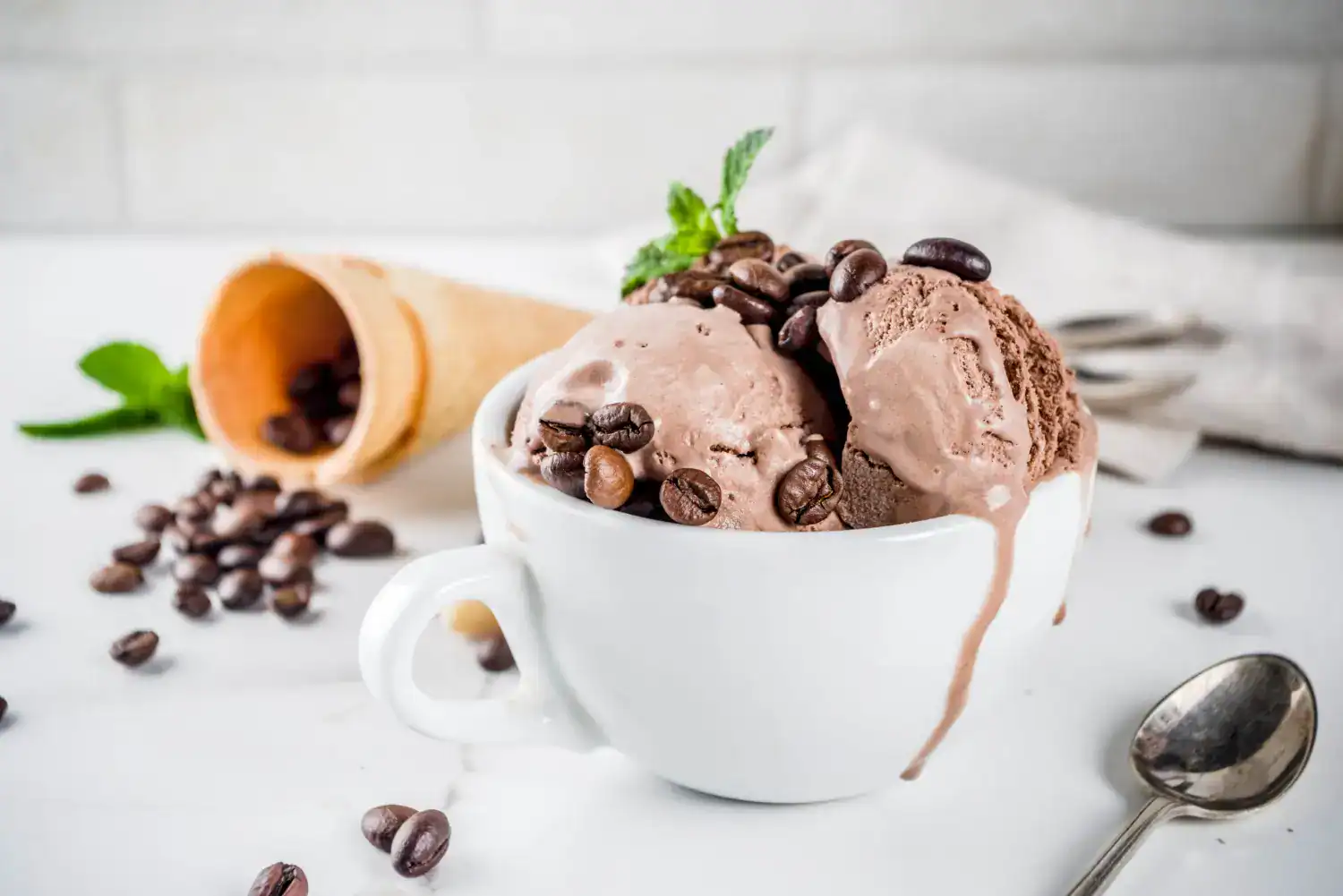 Delicious coffee gelato topped with chocolate and coffee beans in a white cup. Perfect for coffee lo.