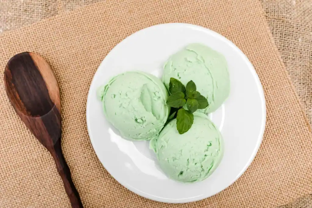 Refreshing cucumber mint sorbet served in a white dish with fresh mint garnish.