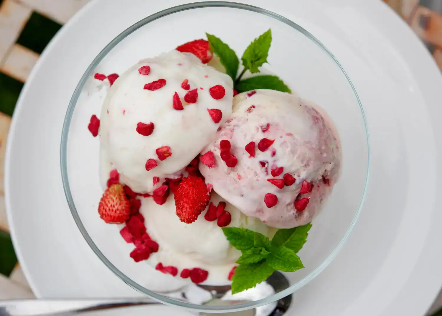 Delicious homemade Ninja Creami frozen yogurt with strawberries and mint, perfect for a refreshing t.