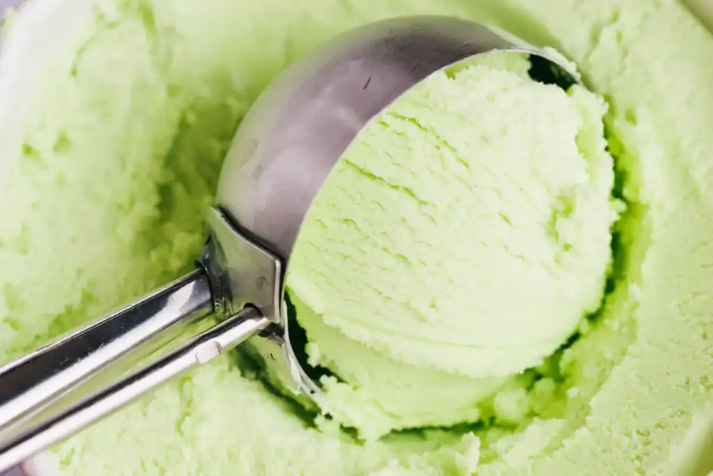 Refreshing green apple sorbet in ice cream scoop for Ninja Creami recipe.