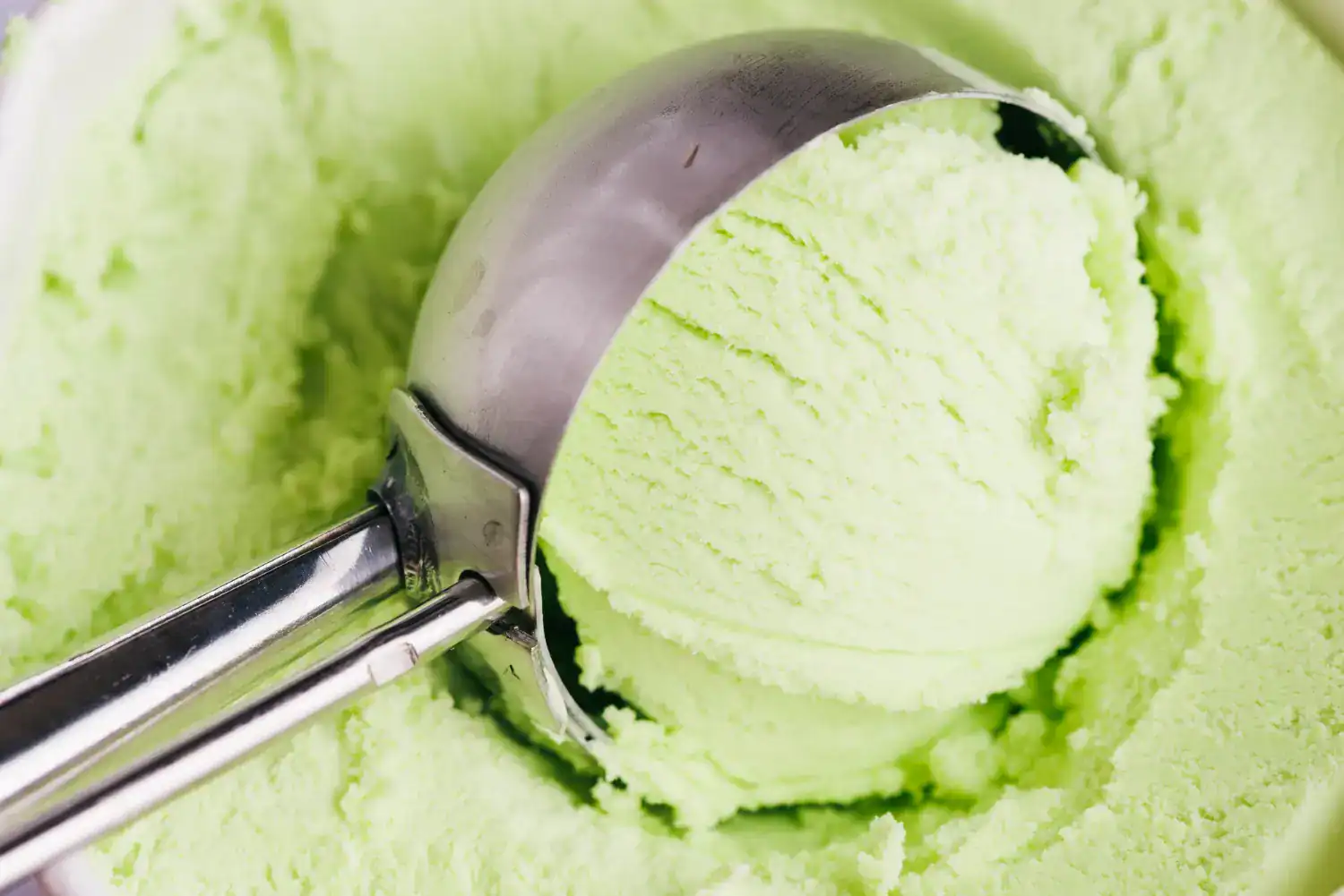 Refreshing green apple sorbet in ice cream scoop for Ninja Creami recipe.