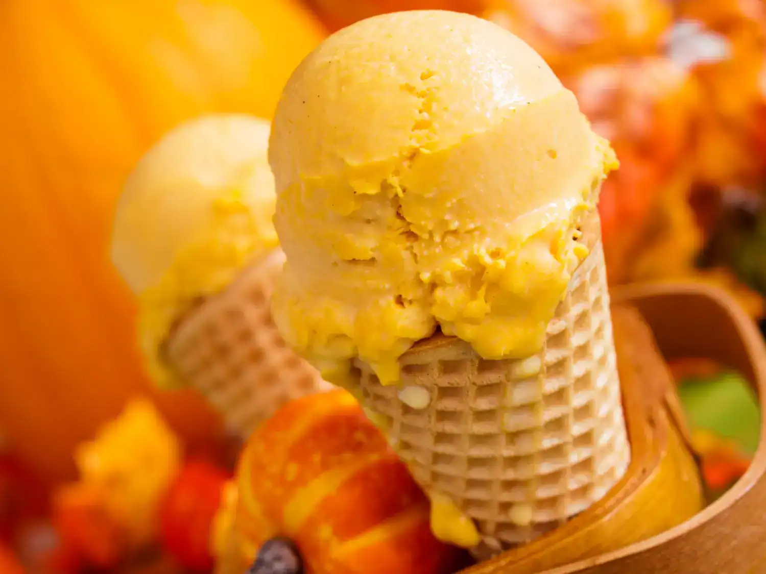 Delicious keto pumpkin spice ice cream in a waffle cone, perfect for fall desserts.