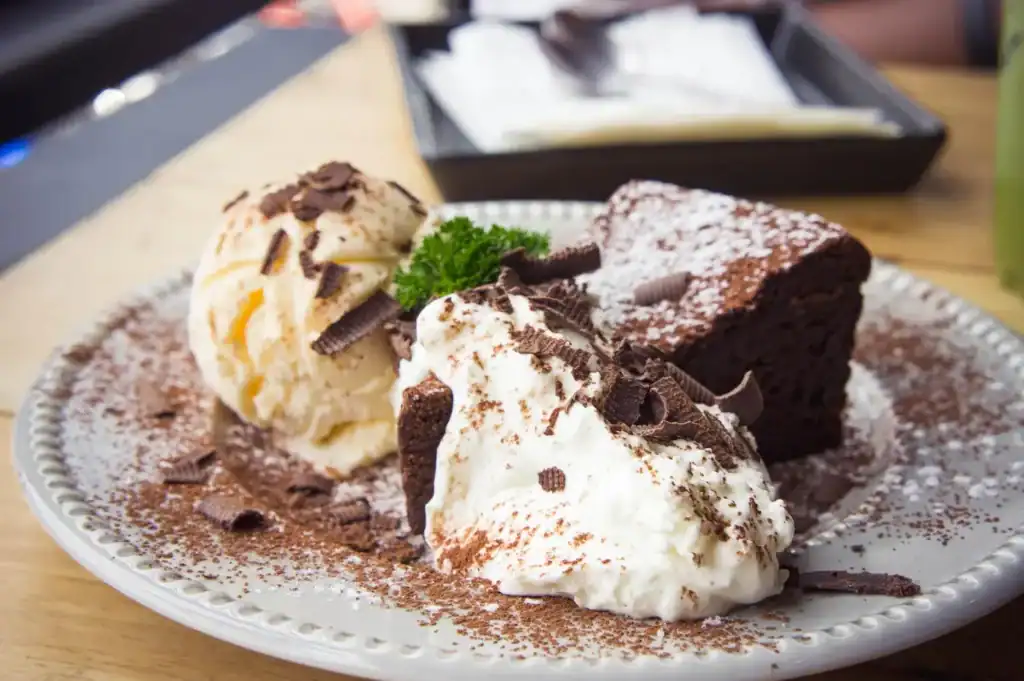 Delicious tiramisu-inspired ice cream served with chocolate shavings and fresh mint.
