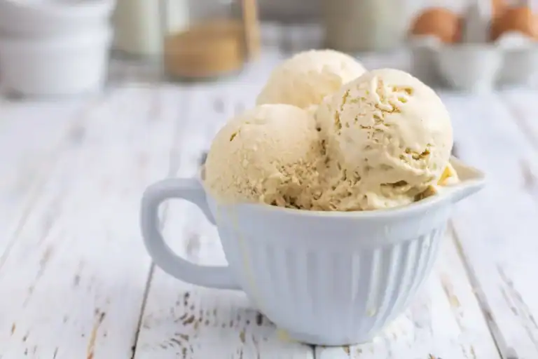 Delicious homemade keto vanilla bean ice cream in a white bowl, perfect for low-carb dessert lovers.