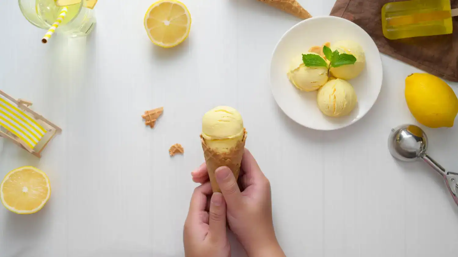 Refreshing lemon ginger sorbet served in a cone with fresh lemon slices and mint garnish.