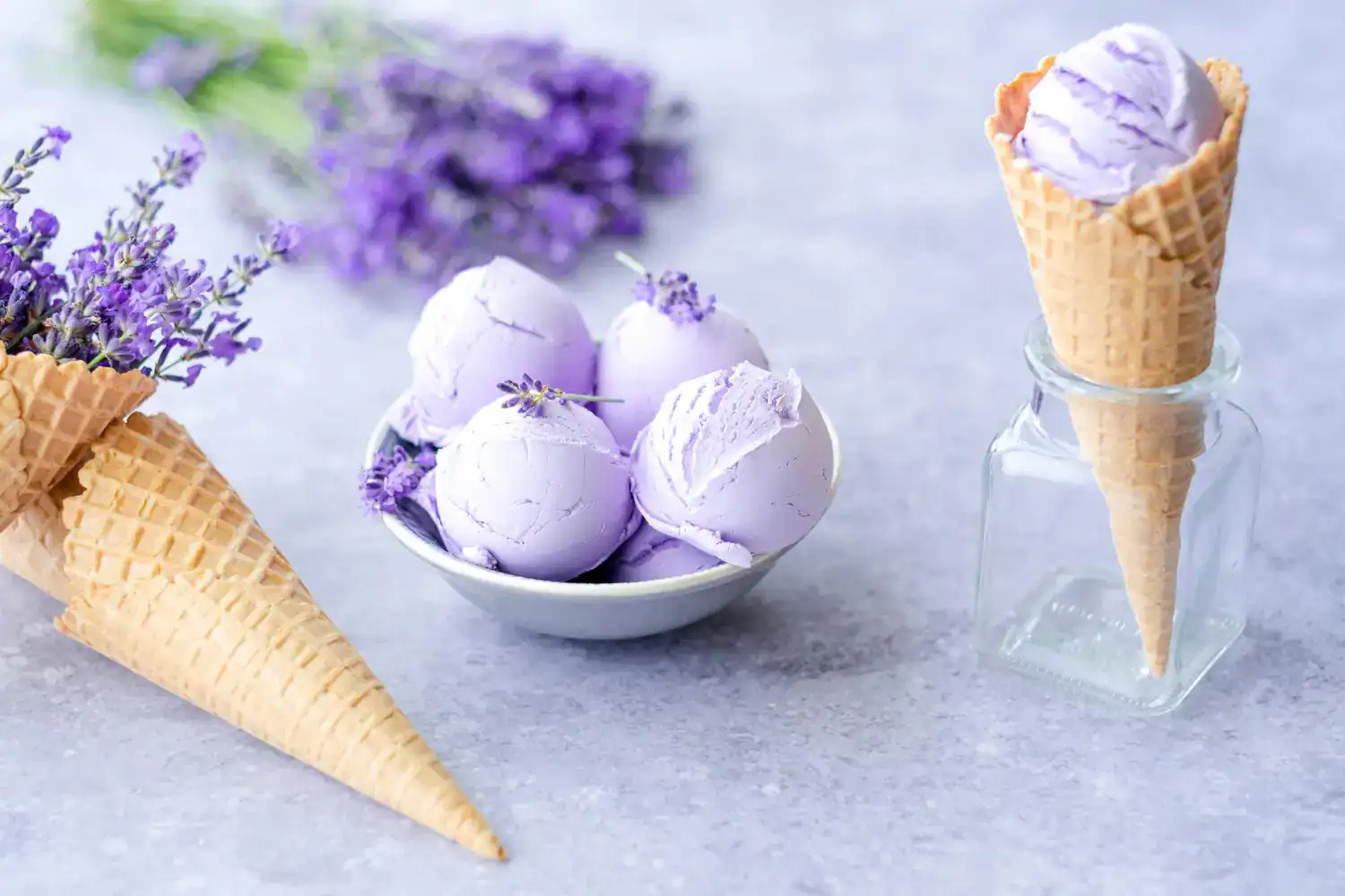 Delicious Lemon Lavender Sorbet served in waffle cones and a bowl, highlighting refreshing flavors a.