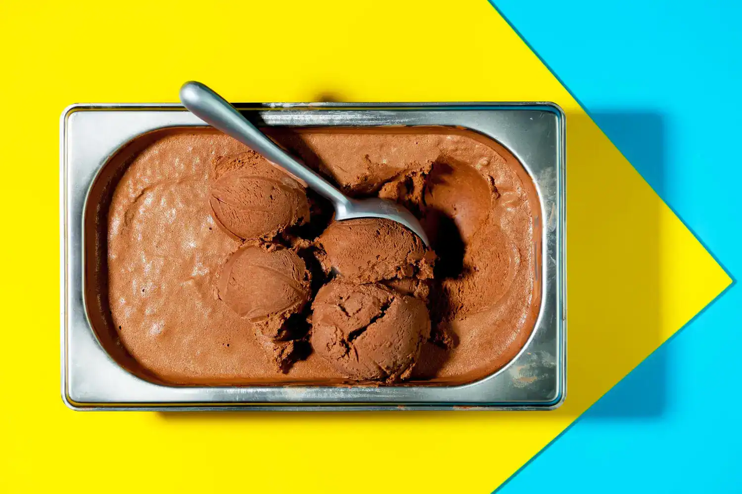 Nutella ice cream in a metal container with a spoon, perfect for a delicious treat.