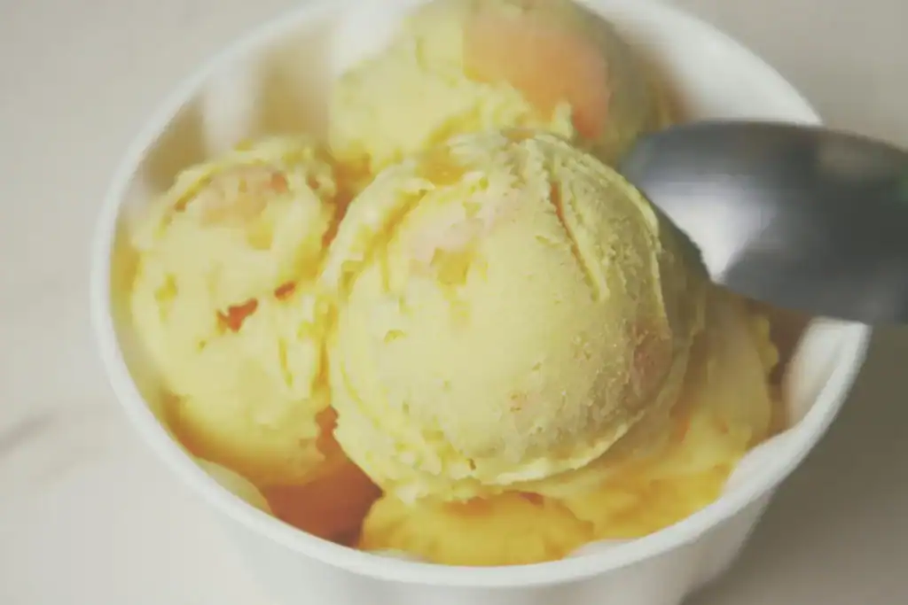 Delicious low-calorie Peach Mango ice cream made with Ninja Creami, perfect for a healthy dessert.
