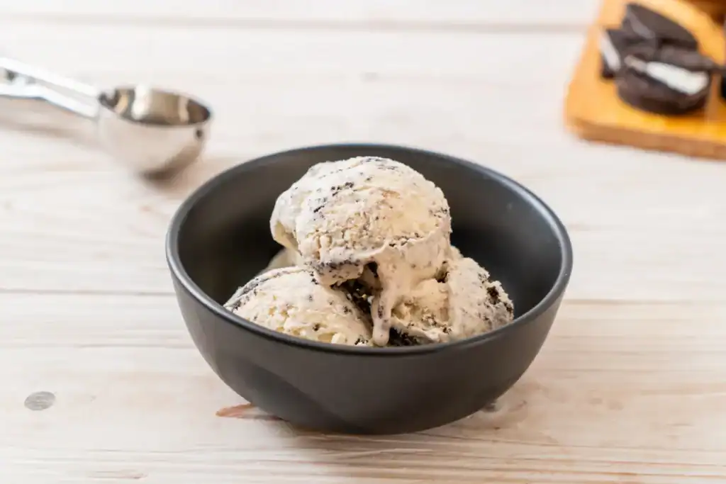Delicious homemade vanilla chia seed ice cream in a black bowl, perfect for a low-calorie dessert.
