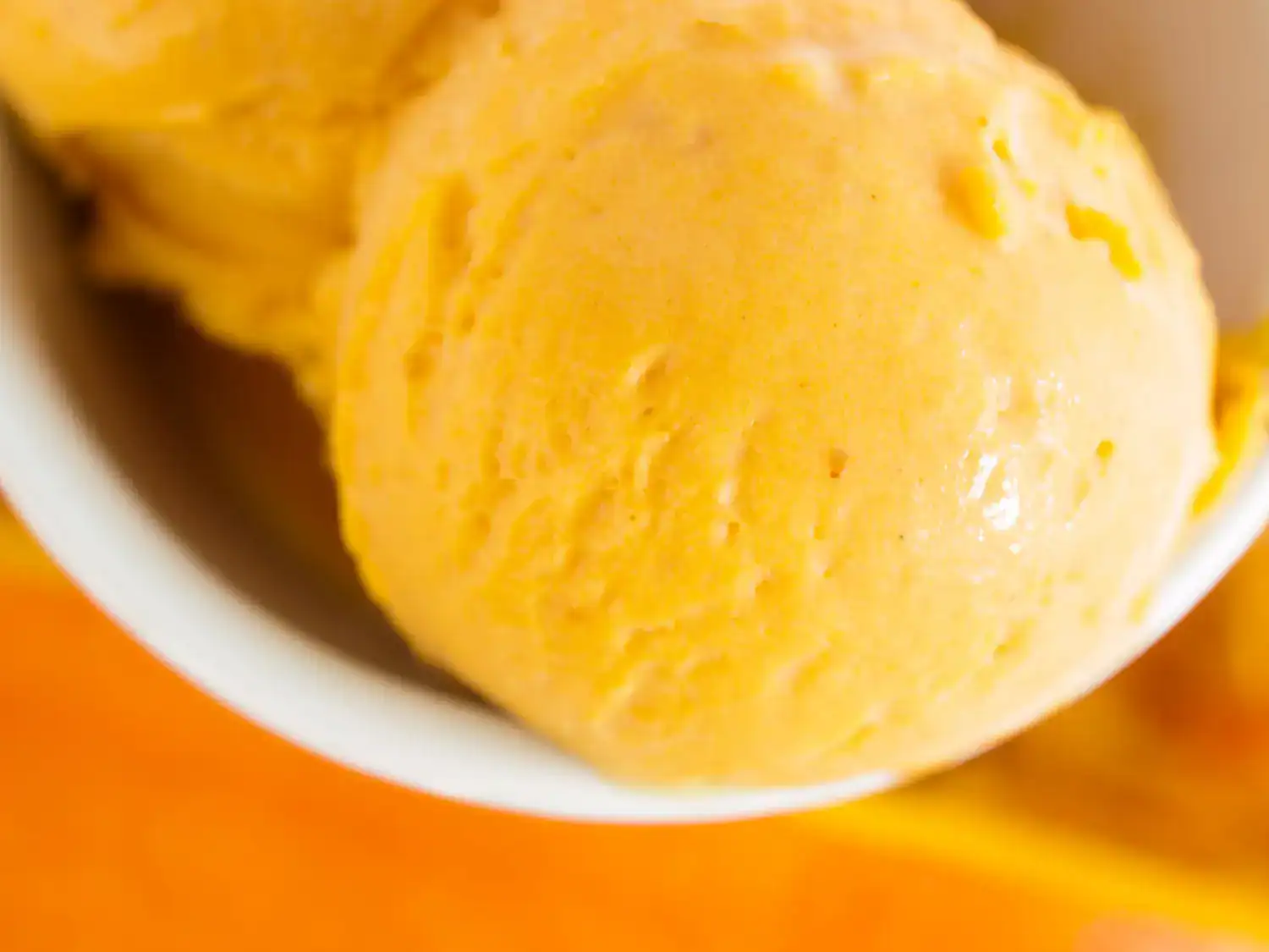 Orange Creamsicle Ice Cream in a bowl, homemade low-calorie recipe.