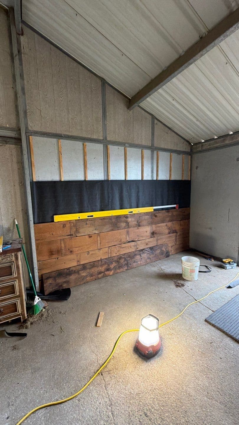 Black tar paper backing installed before reclaimed wood wall in Hicksville NY by Creatively Done Homes Improvements