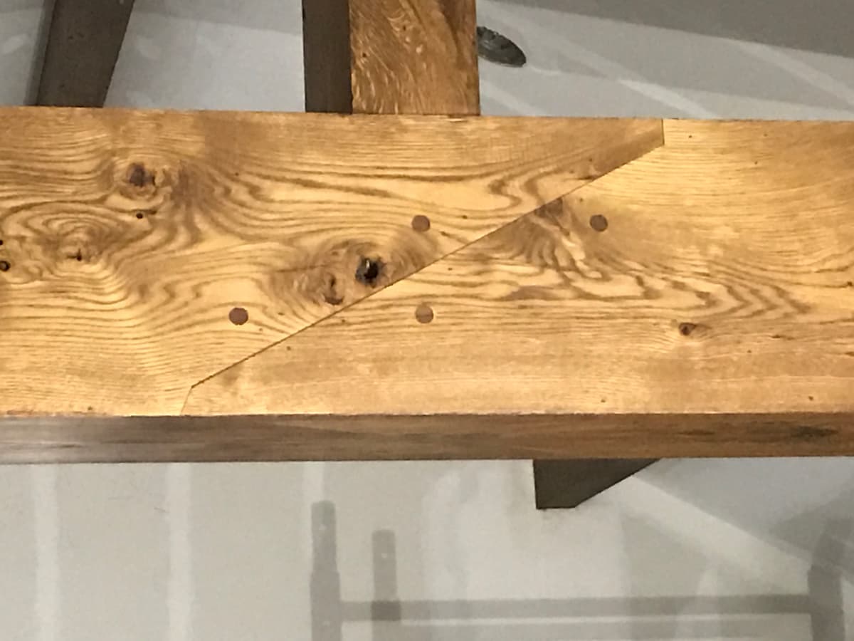 Hand-fabricated walnut dowels in angled lap joint on custom white oak beam wrapping in Sea Cliff NY by Creatively Done Homes Improvements