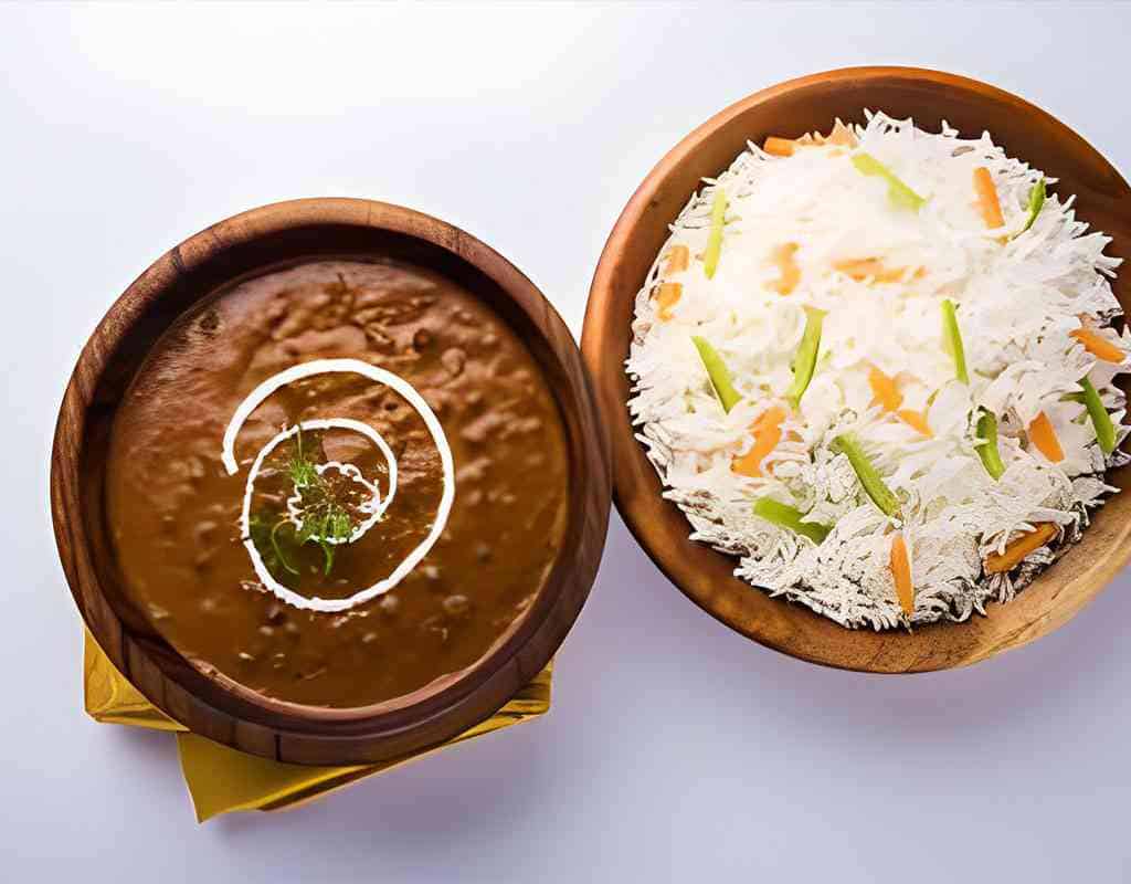 Spicy Indian curry with vegetables served with fresh vegetable salad at Crown Indian Cuisine.