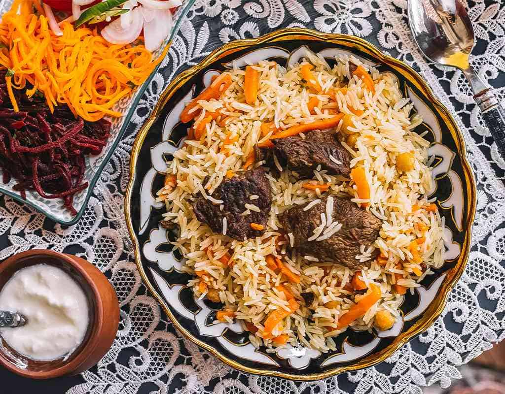 Steamed biryani with tender beef chunks, colorful vegetables, and traditional Indian spices.