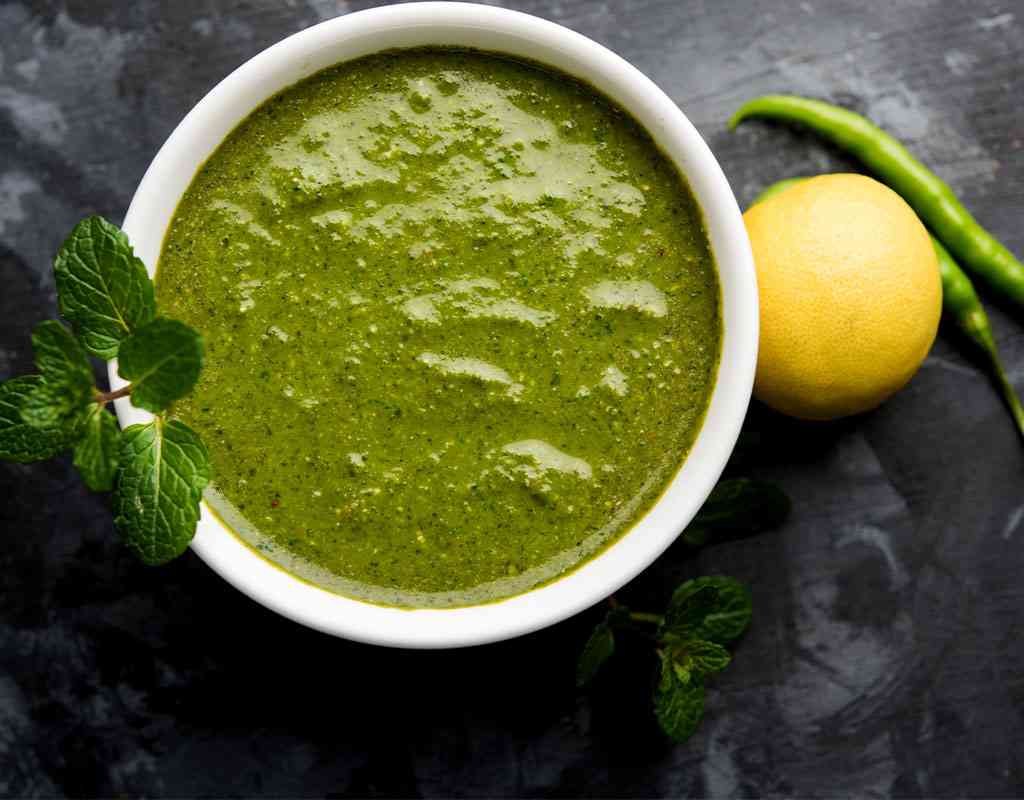 Fresh mint chutney with lemon and green chili, perfect for Indian cuisine.