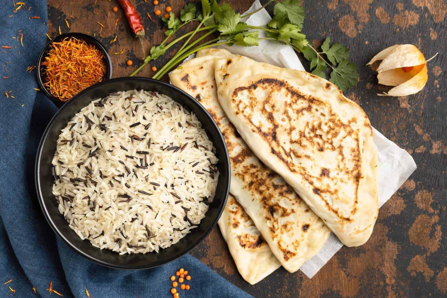 Steamed Basmati rice with naan bread and Indian spices, showcasing Crown Indian Cuisine's authentic flavor.
