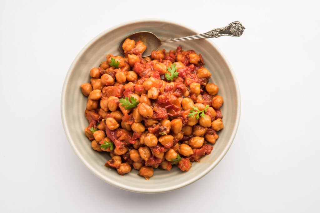 Savory chickpea curry with tomatoes and fresh cilantro, authentic Indian cuisine.