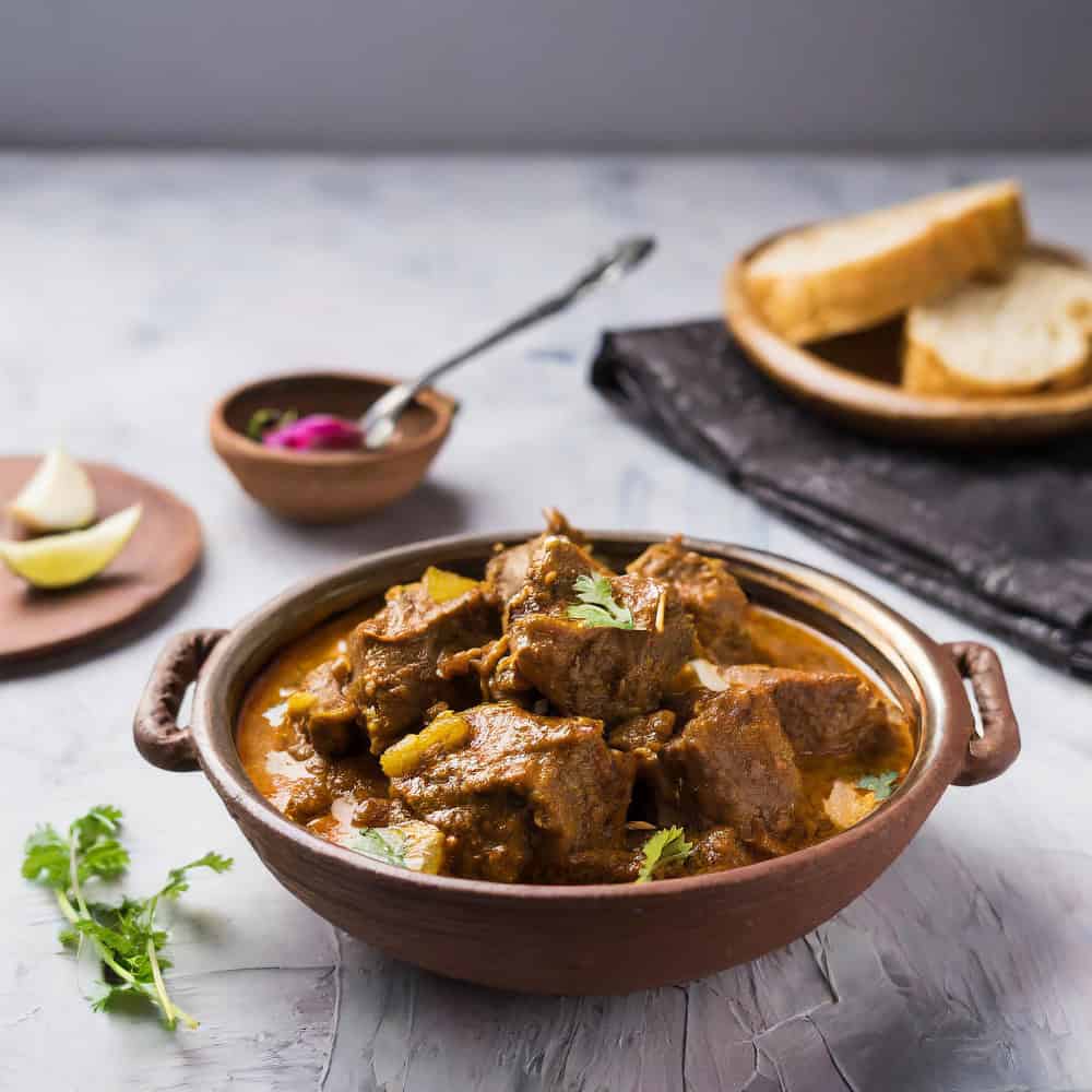 Rich Indian curry with tender meat in a traditional clay bowl ideal for Indian cuisine Windang.